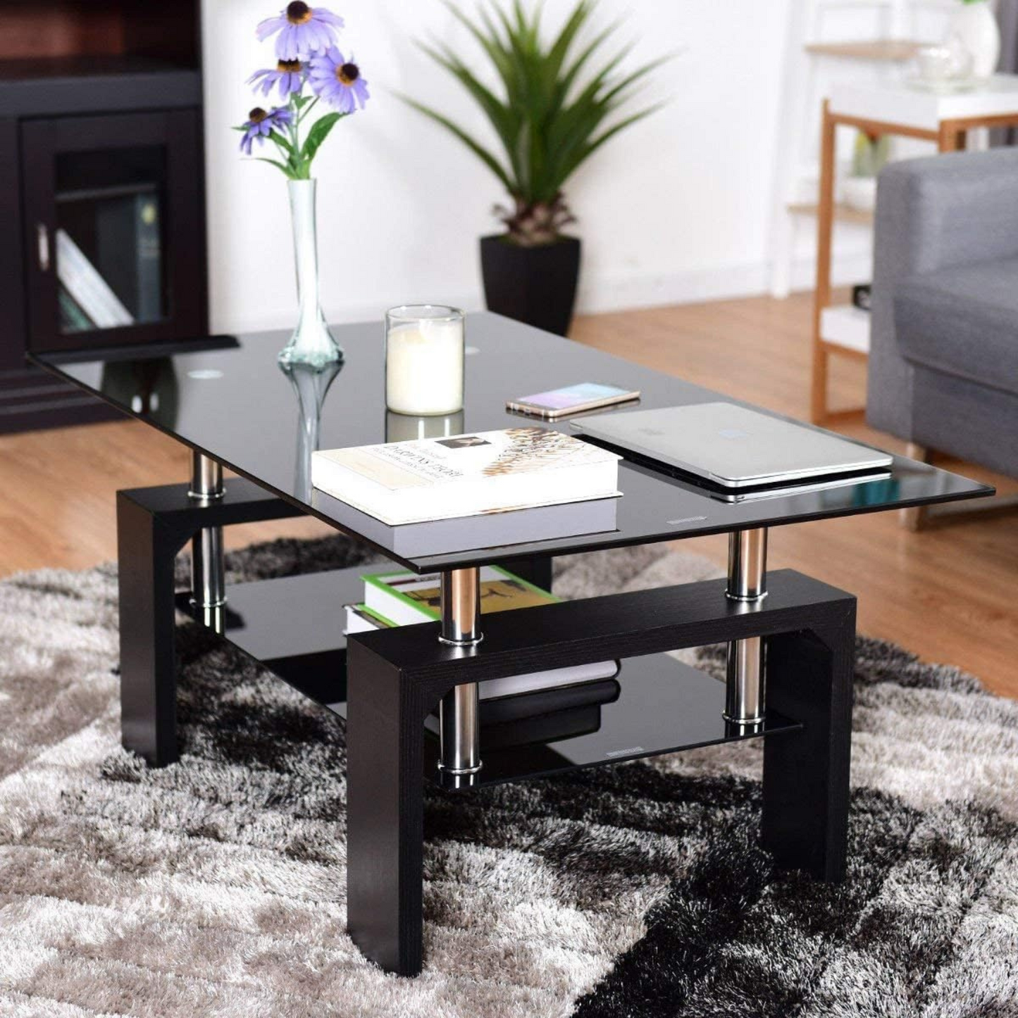 Coffee Table with Stained Glass Top for Living Room | Black from AHF Depot - Top-down view of a modern living room featuring a sleek black metal-framed coffee table with a stained glass top. Positioned in front of a stylish couch and a plant.