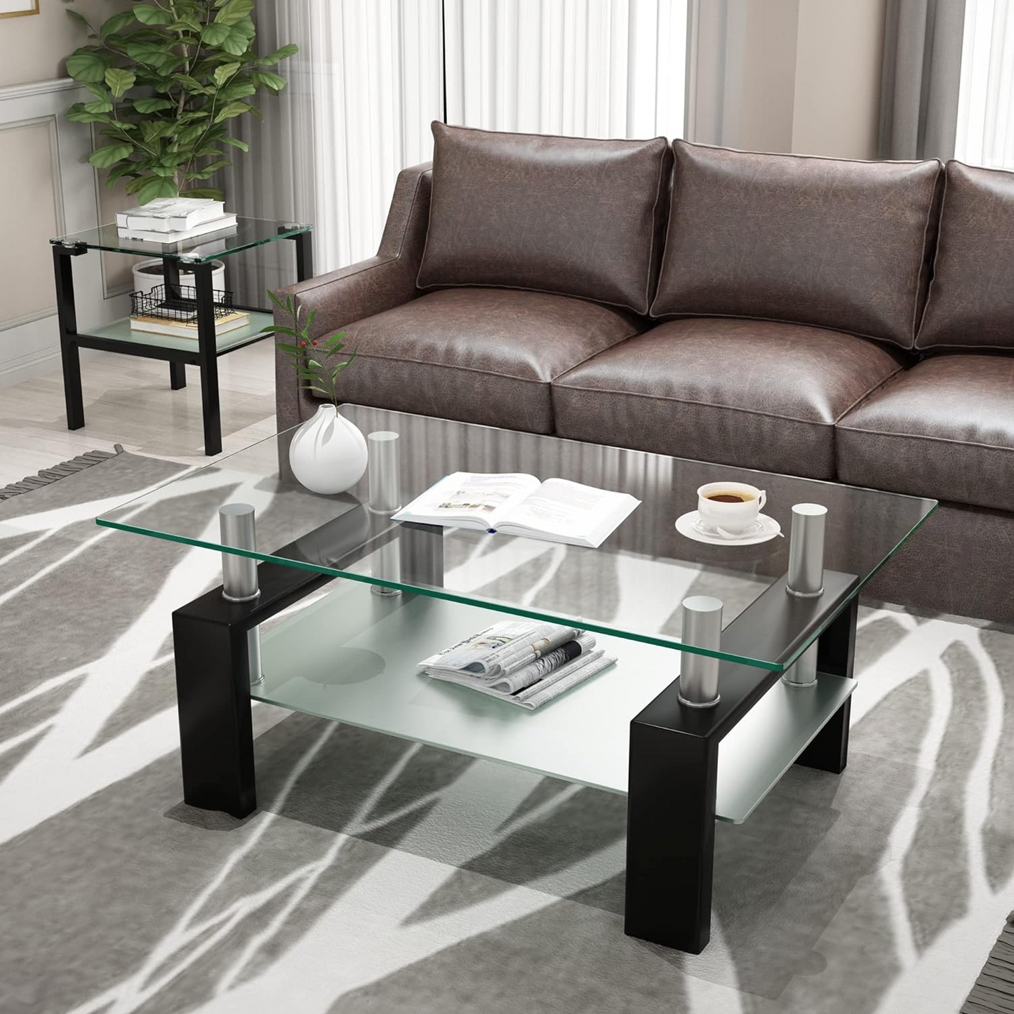 Coffee Table with Glass Top for Living Room | Black from AHF Depot - Modern living room scene featuring a sleek black metal-framed coffee table with a mirrored glass top. Positioned in front of a stylish couch and a plant. 