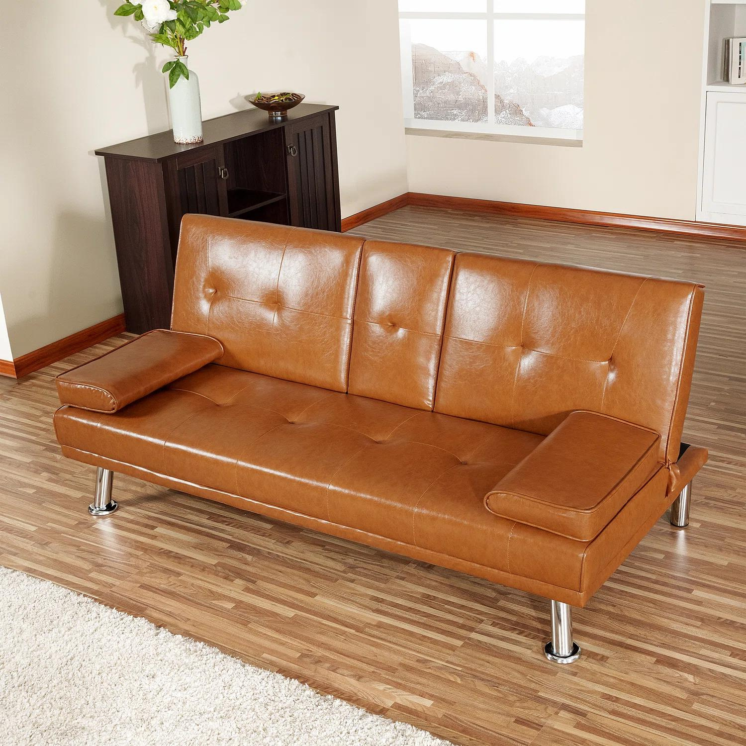 Couch Bed Futon Sleeper Sofa for Living Room | Tan Faux Leather from AHF Depot - Tan leather futon with center cupholders displayed against oakwood floor in a modern living room scene positioned in the center of the room. 