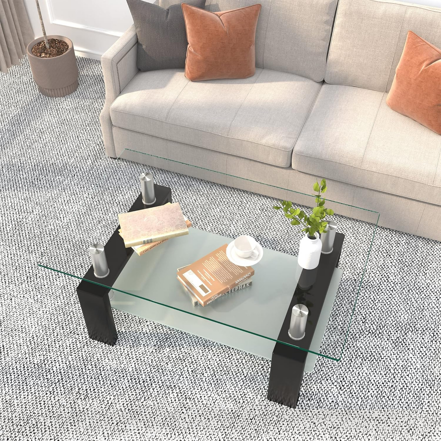 Coffee Table with Glass Top for Living Room | Black from AHF Depot - Top-down view of a modern living room featuring a sleek black metal-framed coffee table with a mirrored glass top. Positioned in front of a stylish couch and a plant. 