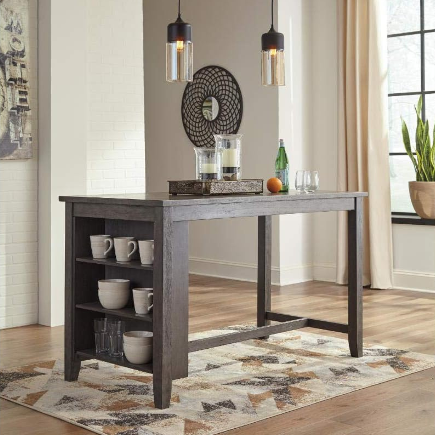 Rustic Counter Height Dining Table with Storage | Dark Oak from AHF Depot - Dining table featuring a dark gray wash design and built-in shelving, placed in a modern kitchen below two single bulb hanging chandelier lights.