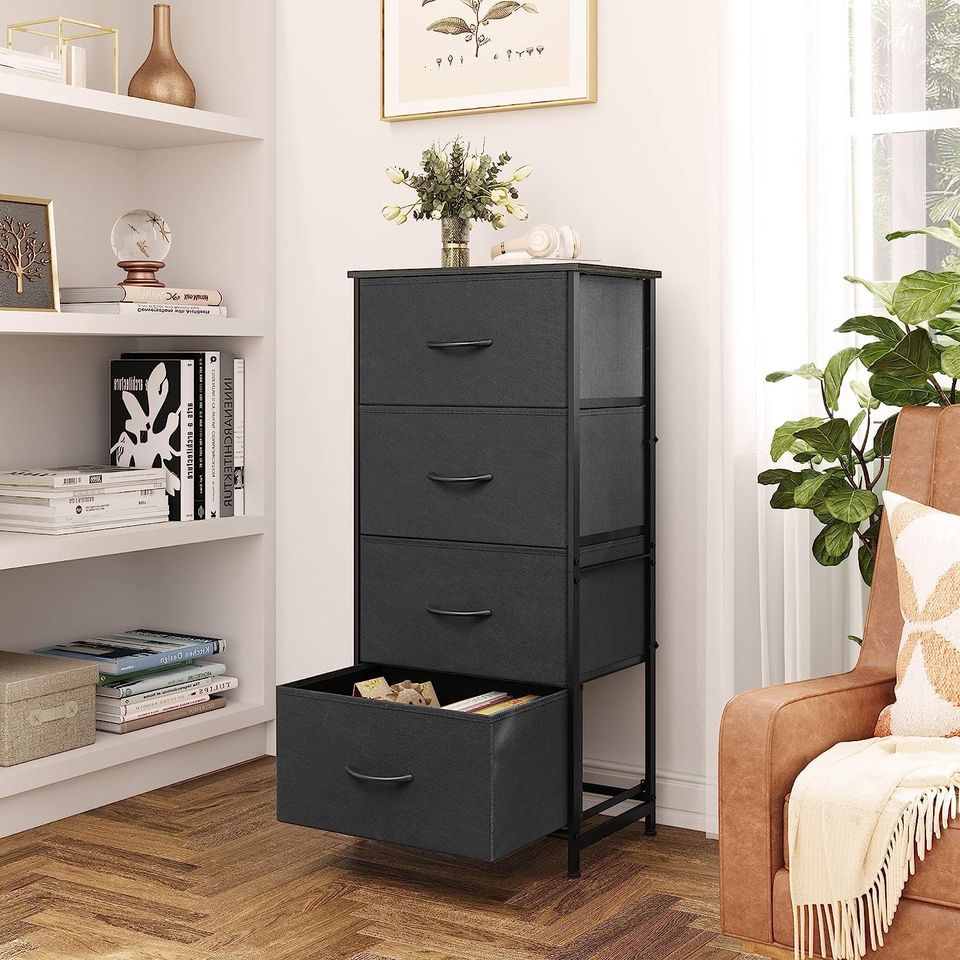 Side Table/End Table with 4 Drawers for Bedroom Storage | Black from AHF Depot - Black 4 drawer side table in a modern light tone living room setting with one drawer open against an off-white wall.