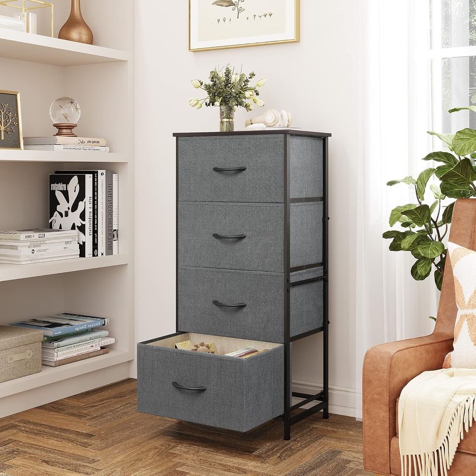 Side Table/End Table with 4 Drawers for Bedroom Storage | Grey from AHF Depot - Grey 4 drawer side table in a modern light tone living room setting with one drawer open against an off-white wall.