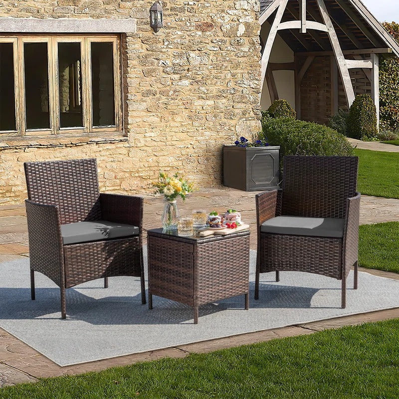 Outdoor Patio Chairs and Table Set | Brown/Grey from AHF Depot - Modern brown rattan frame patio conversation set with grey cushions and small glass top table, set against a sunny outdoor patio setting.