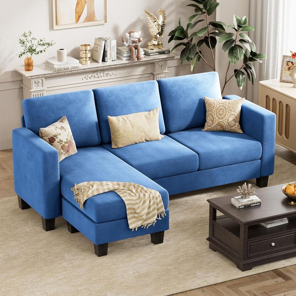 Couch Sectional Sofa with Ottoman for Living Room | Blue from AHF Depot - Blue sectional sofa with a right-side chaise, complementing a light tone modern living room scene placed in front of a fireplace.