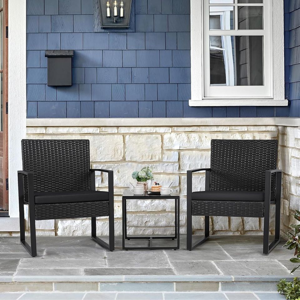  Outdoor Patio Chairs and Table Set | Black/Black from AHF Depot - Modern black frame patio conversation set with black cushions and small glass top table, set against a sunny outdoor patio setting.