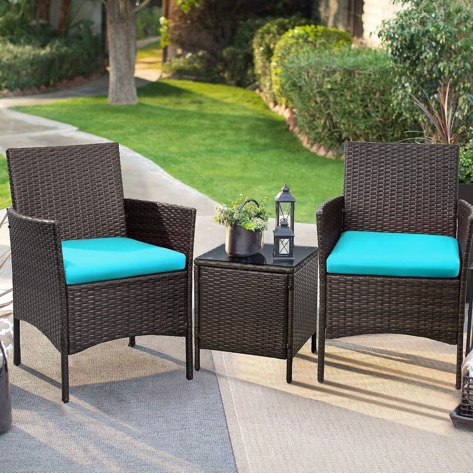 Outdoor Patio Chairs and Table Set | Brown/Teal from AHF Depot - Modern brown rattan frame patio conversation set with teal blue cushions and small glass top table, set against a sunny outdoor patio setting.