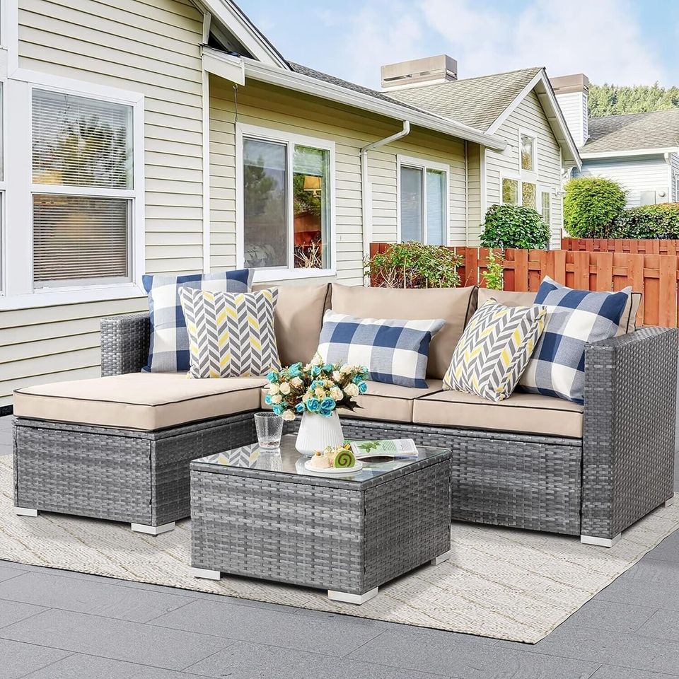 Outdoor Patio Sofa Set with Table | Grey/Tan from AHF Depot - Grey sectional couch with tan cushions and a small glass top table, complemented by breakfast essentials and a few books, set against a sunny outdoor patio backdrop.