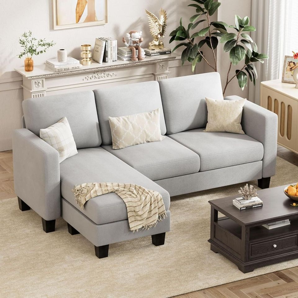 Couch Sectional Sofa with Ottoman for Living Room | Grey from AHF Depot - Grey sectional sofa with a right-side chaise, complementing a light tone modern living room scene placed in front of a fireplace.