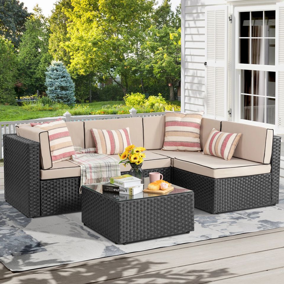 Outdoor Patio Sofa Set with Table | Black/Tan from AHF Depot - Black sectional couch with tan cushions and a small glass top table, complemented by breakfast essentials and a few books, set against a sunny outdoor patio backdrop.