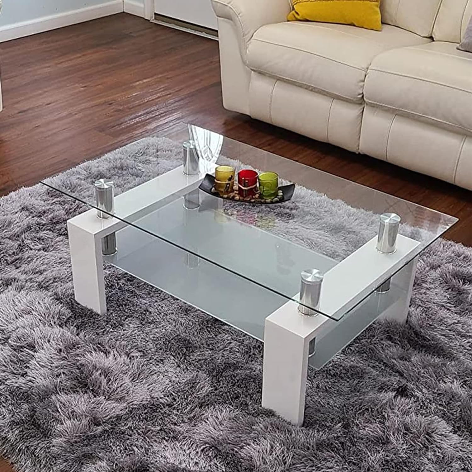 Coffee Table with Glass Top for Living Room | White from AHF Depot - Top-down view of a modern living room featuring a sleek white metal-framed coffee table with a mirrored glass top. Positioned in front of a stylish couch and a plant.