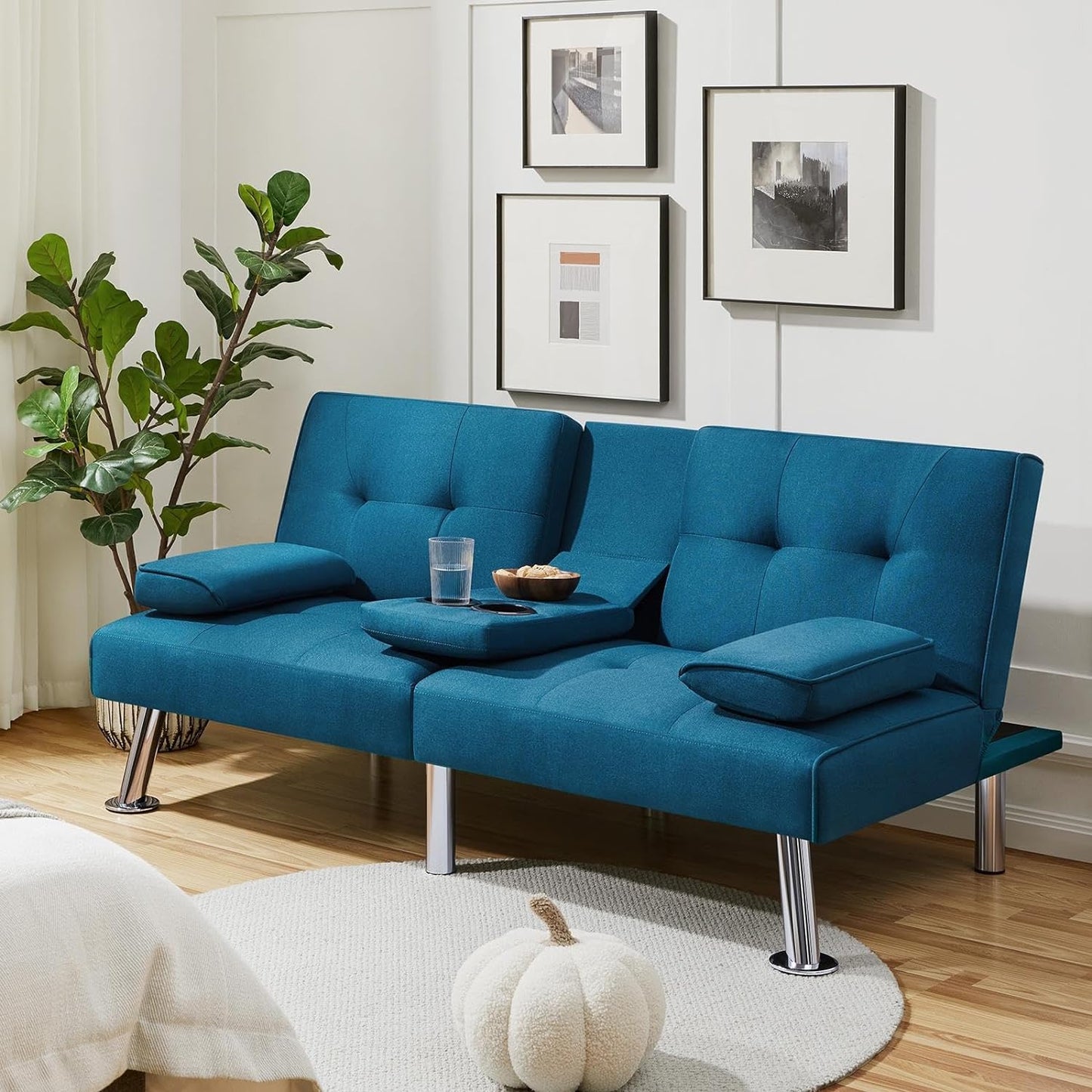 Couch Bed Futon Sleeper Sofa for Living Room | Blue from AHF Depot - Blue fabric futon with center cupholders displayed against a modern living room scene, positioned beside and indoor plant.