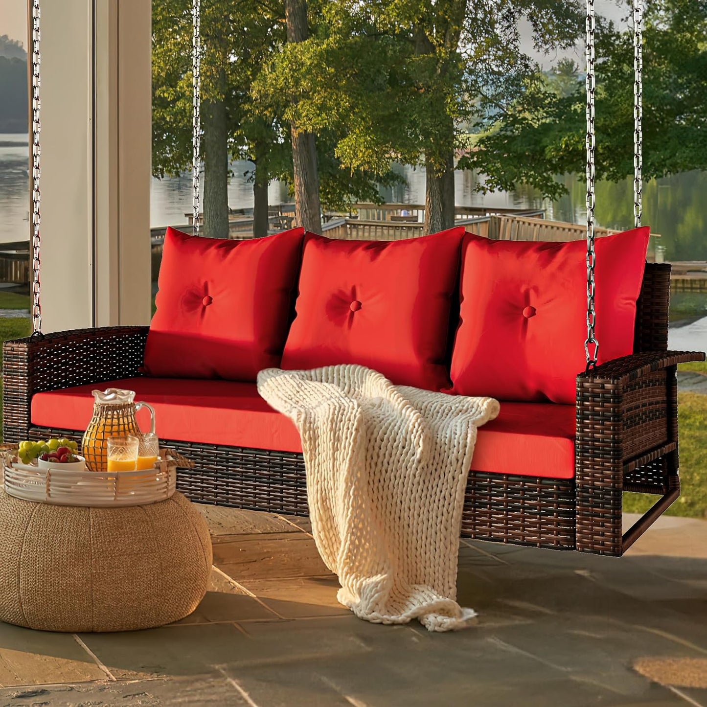 Outdoor Padded Porch Swing Hanging 3 Seater Chair | Brown/Red from AHF Depot - Modern brown rattan frame hanging porch swing with red cushions set against a sunny outdoor patio setting.