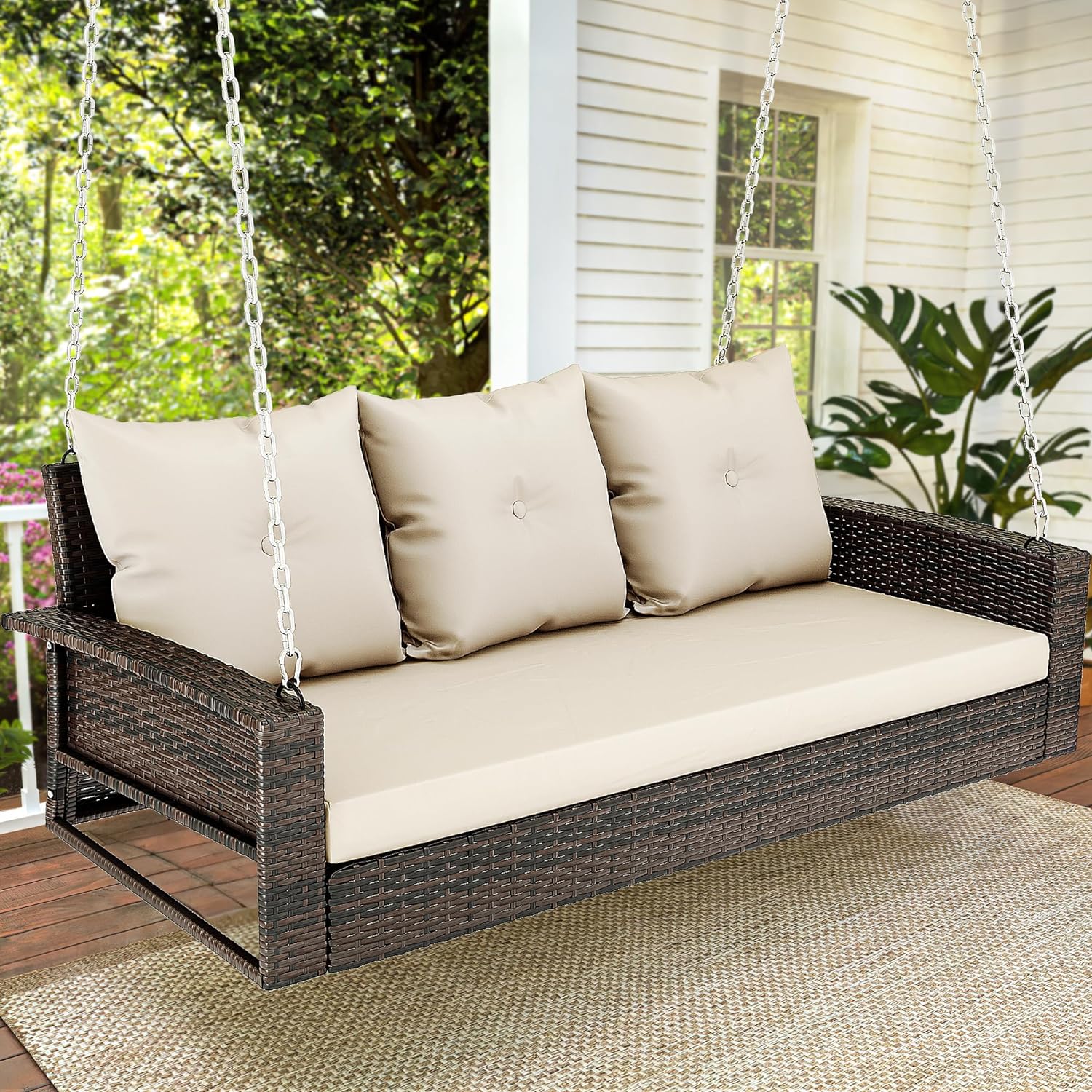 Outdoor Padded Porch Swing Hanging 3 Seater Chair | Brown/Tan from AHF Depot - Modern brown rattan frame hanging porch swing with tan cushions set against a sunny outdoor porch setting.