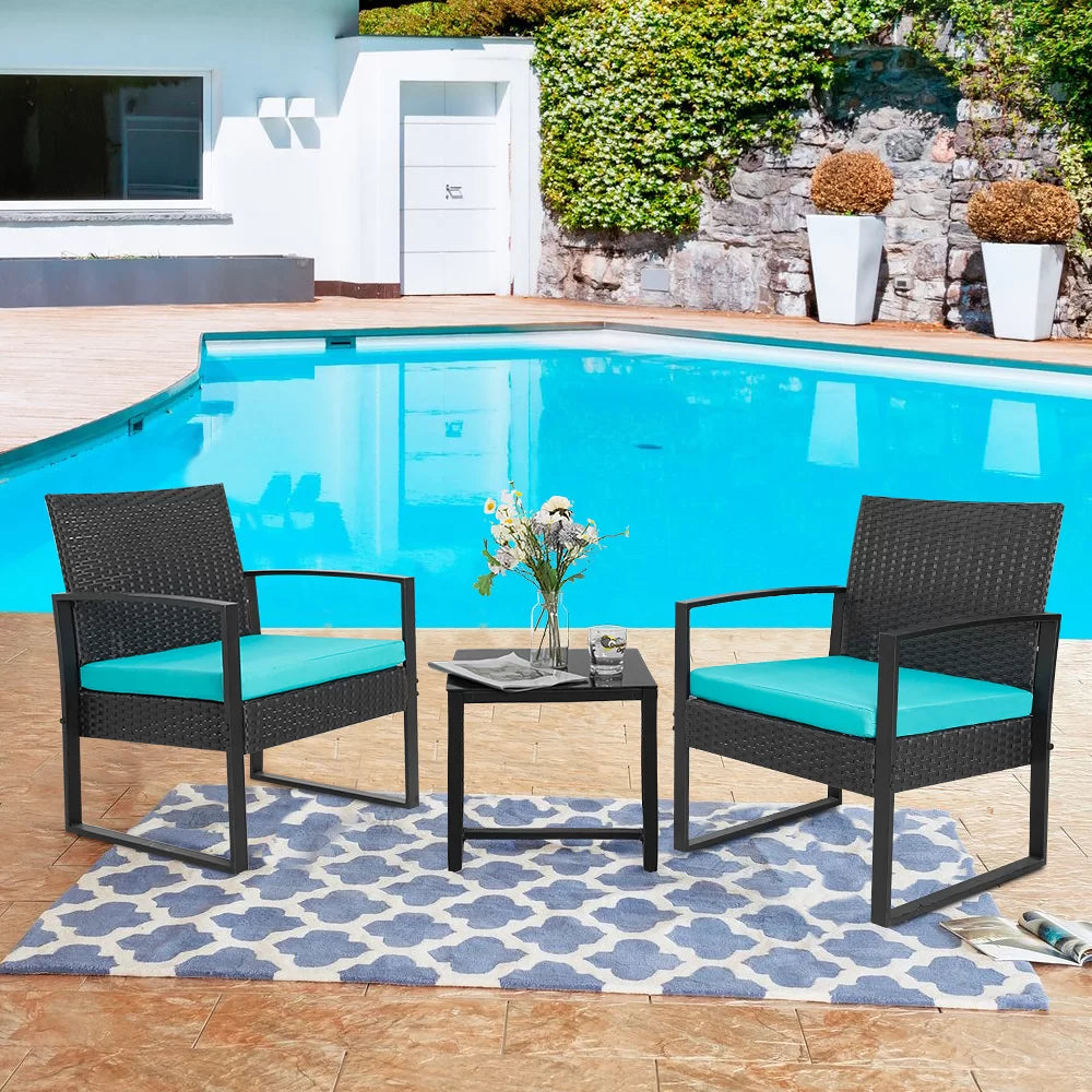 Outdoor Patio Chairs and Table Set | Black/Teal from AHF Depot - Modern black frame patio conversation set with teal blue cushions and small glass top table adorned with two glasses of iced tea, set amidst a sunny outdoor poolside scene.