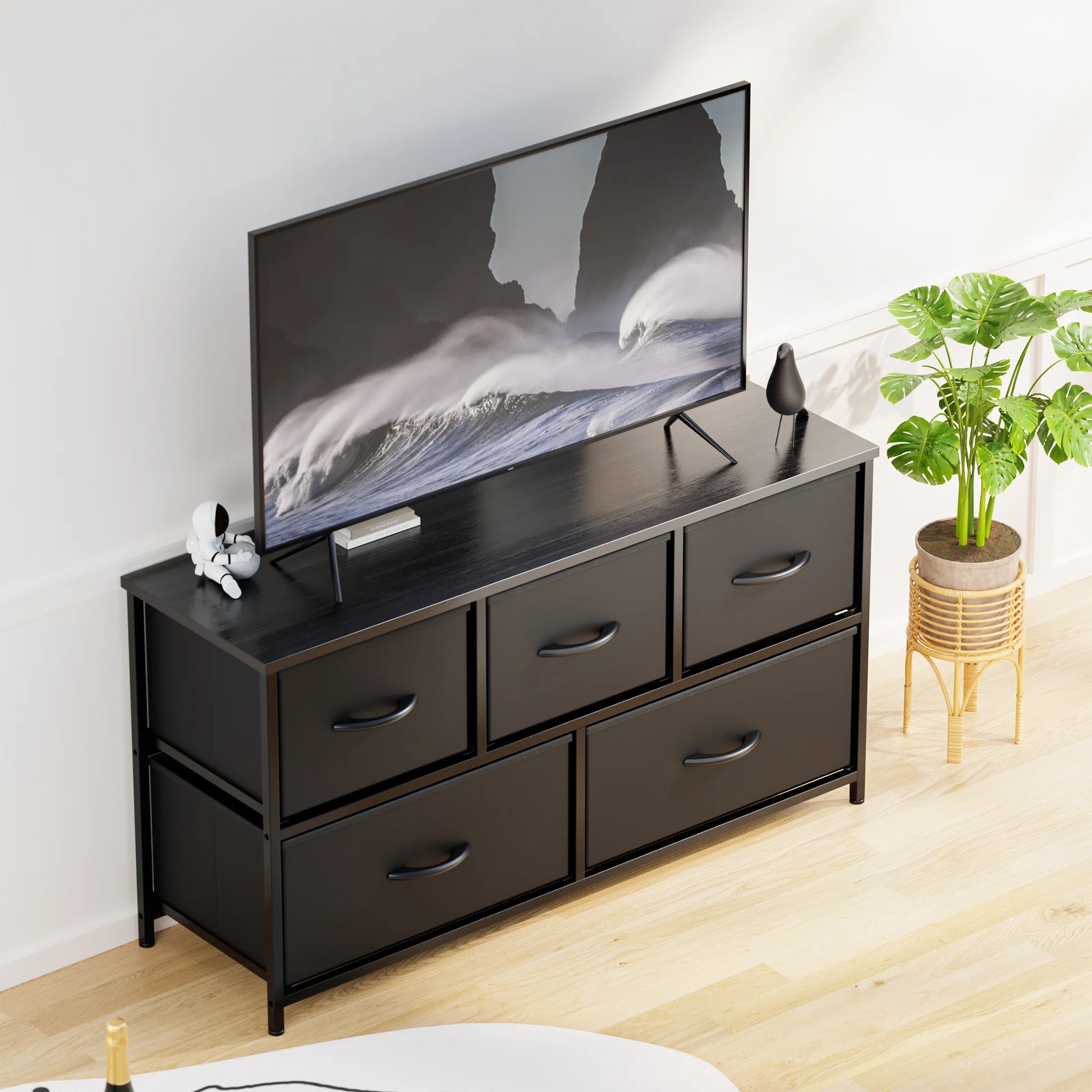 Dresser with 5 Drawers for Bedroom | Black from AHF Depot - Black 5 drawer dresser in a modern light tone bedroom setting with a tv on the dresser.