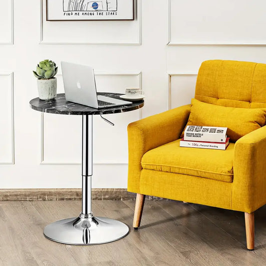 Bar Table Round with Adjustable Height and Swivel | Black from AHF Depot - Modern black marble top bar table with a sleek silver frame, situated beside a yellow chair, in a stylish light-toned living room scene.